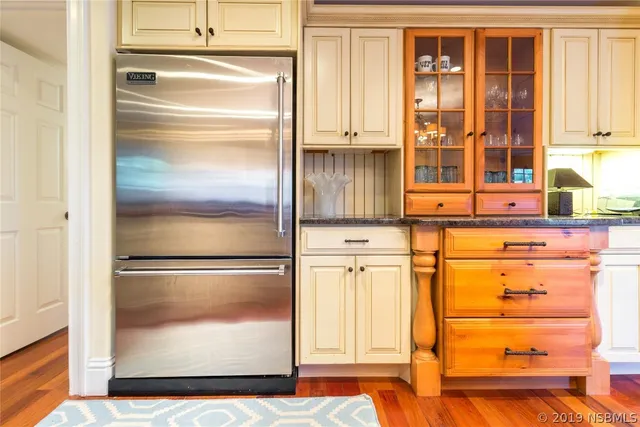 a close view of walk in closet with wooden floor