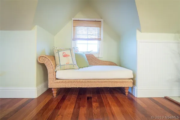a bed sitting in a bedroom next to a window