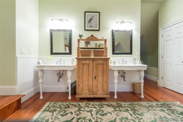 a view of kitchen with wooden floor and electronic appliances