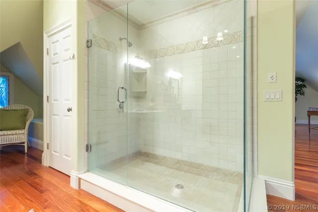 a bathroom with a glass shower door