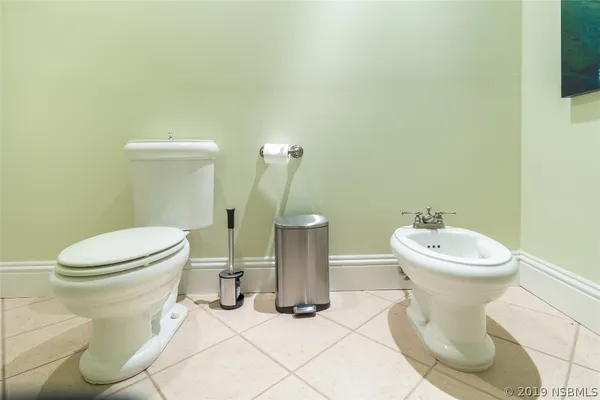 a white toilet sitting next to a white sink