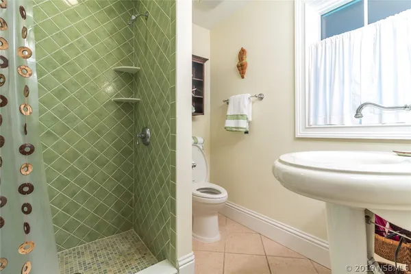 a bathroom with a shower and a toilet