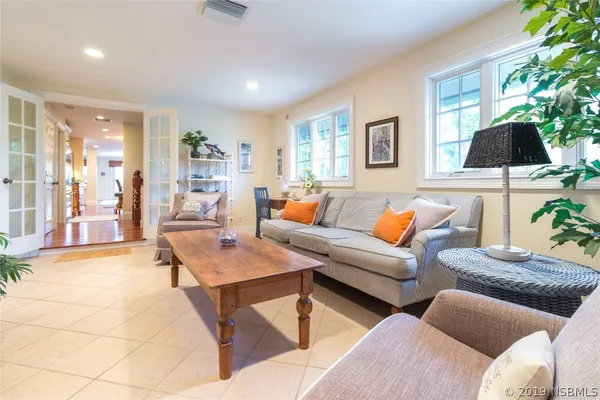a living room with furniture and a potted plant