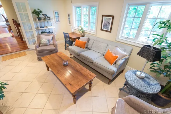 a living room with furniture and a potted plant