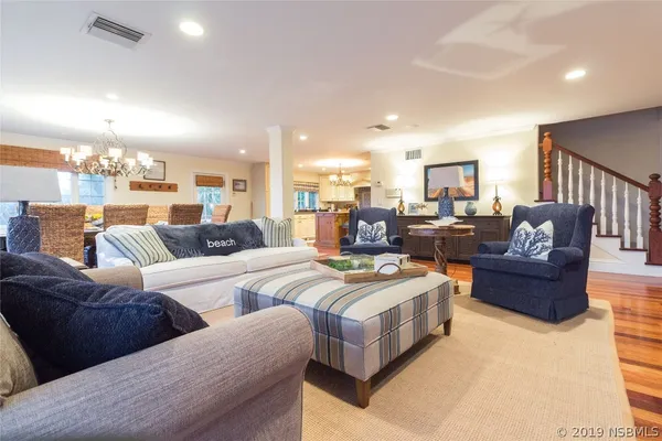 a living room with furniture and a view of kitchen