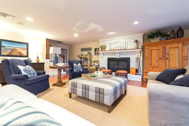 a living room with furniture fireplace and flat screen tv