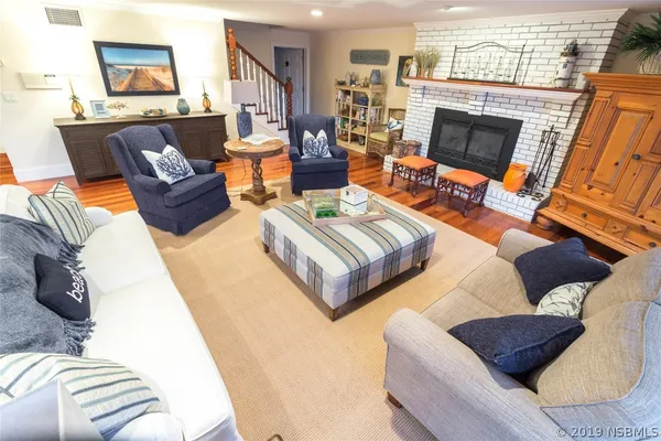a living room with furniture and a fireplace