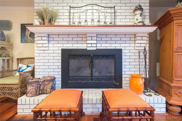 a living room with furniture fireplace and a window