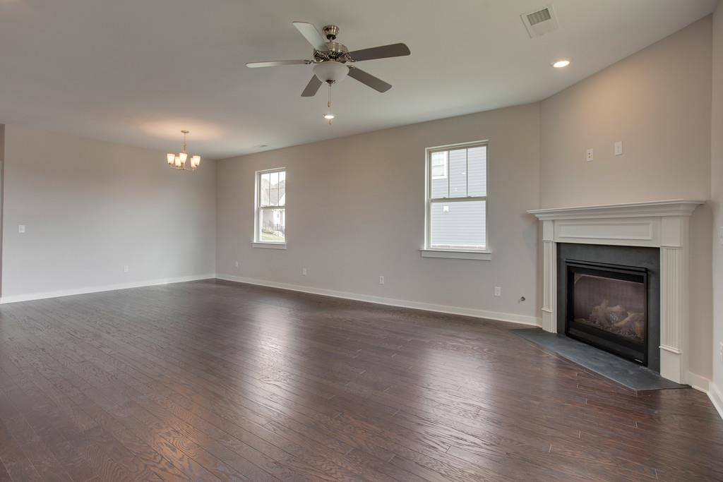 204 Sable Lane Spring Hill, TN 37174 - Photo 8 of 24 Family room with fireplace and hardwoods. Photo is of same plan in a different community.