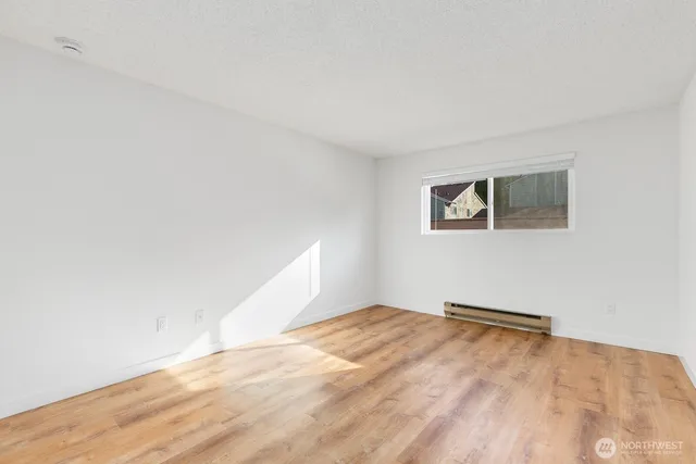 a view of empty room with wooden floor