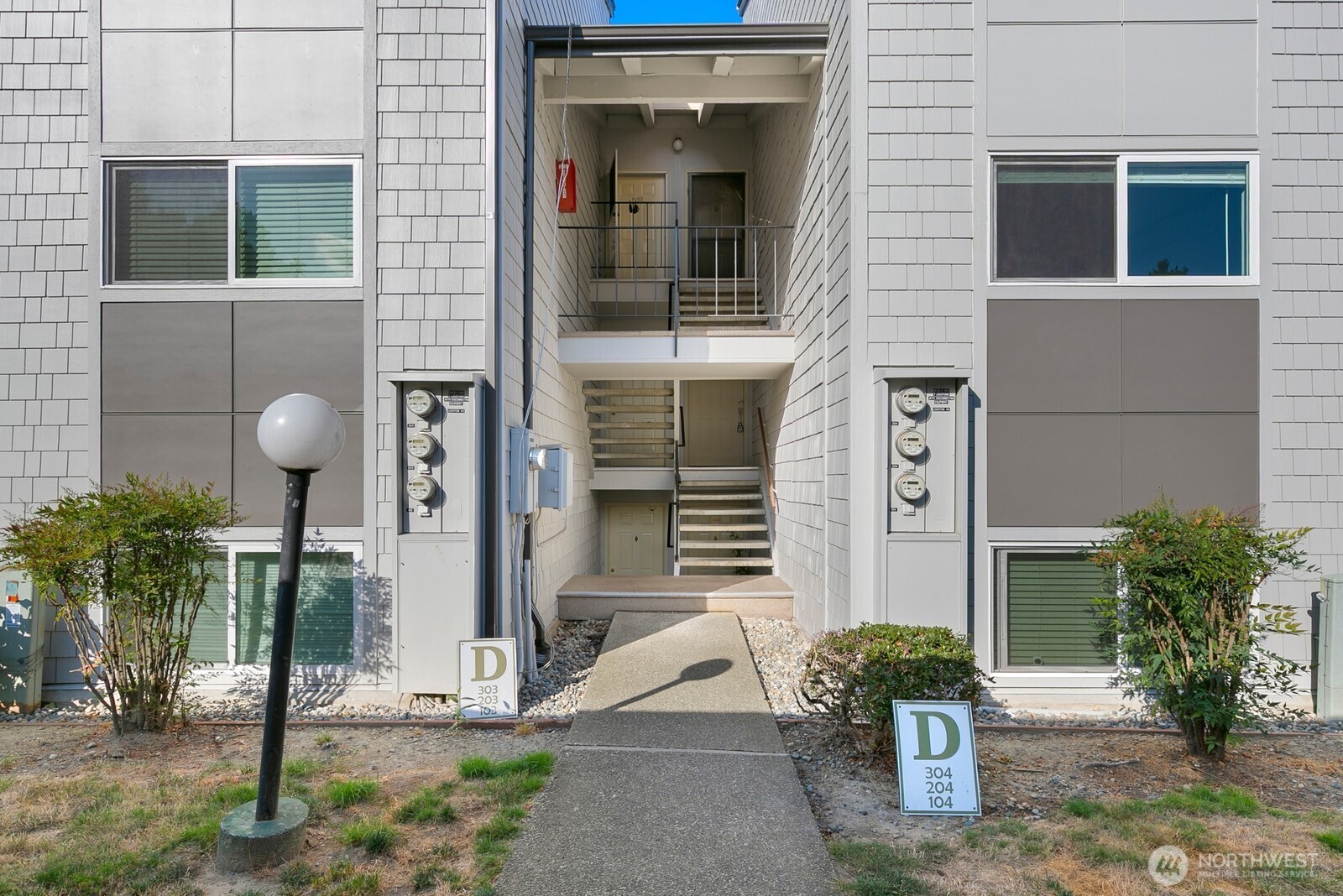 2020 Grant Avenue South, Unit D204 Renton, WA 98055 - Photo 15 of 16 a front view of a house with a yard