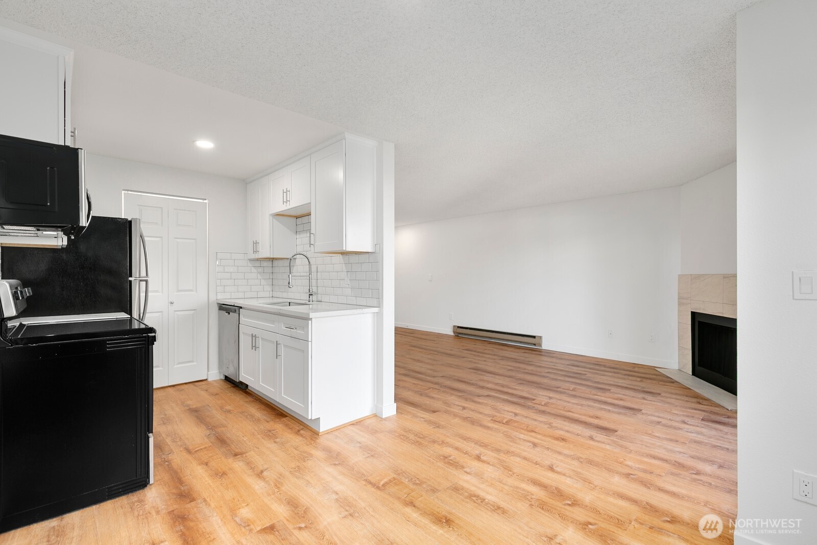 2020 Grant Avenue South, Unit D204 Renton, WA 98055 - Photo 5 of 16 a kitchen with granite countertop a refrigerator stove and sink