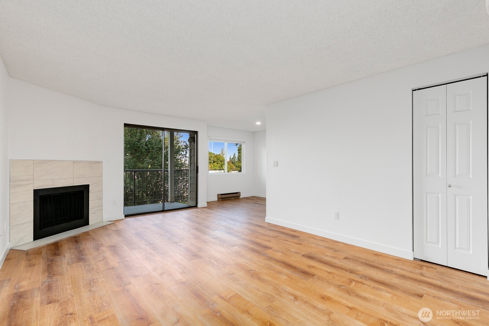 2020 Grant Avenue South, Unit D204 Renton, WA 98055 - Photo 7 of 16 a view of an empty room with a fireplace and a window