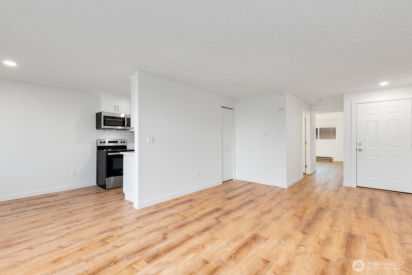 2020 Grant Avenue South, Unit D204 Renton, WA 98055 - Photo 8 of 16 a big room with wooden floor and kitchen view