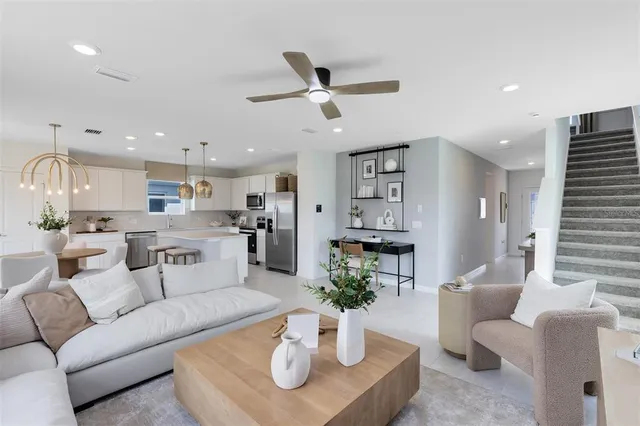 a living room with furniture kitchen and a table