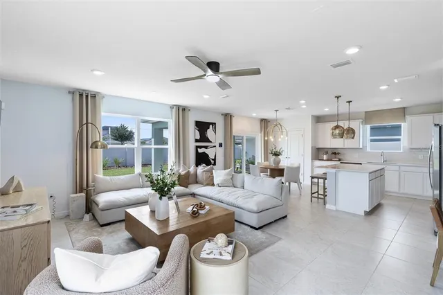 a living room with furniture and a large window