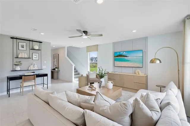 a living room with furniture and a large window