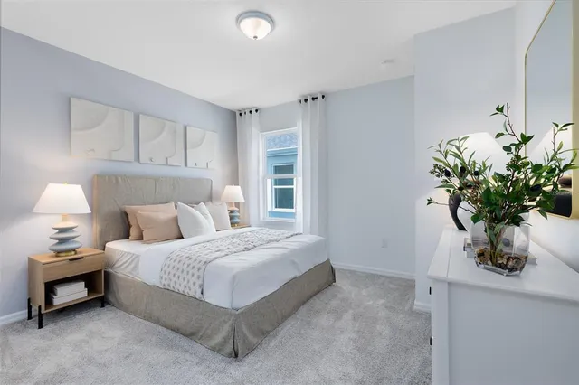 a bedroom with a bed potted plant and a window