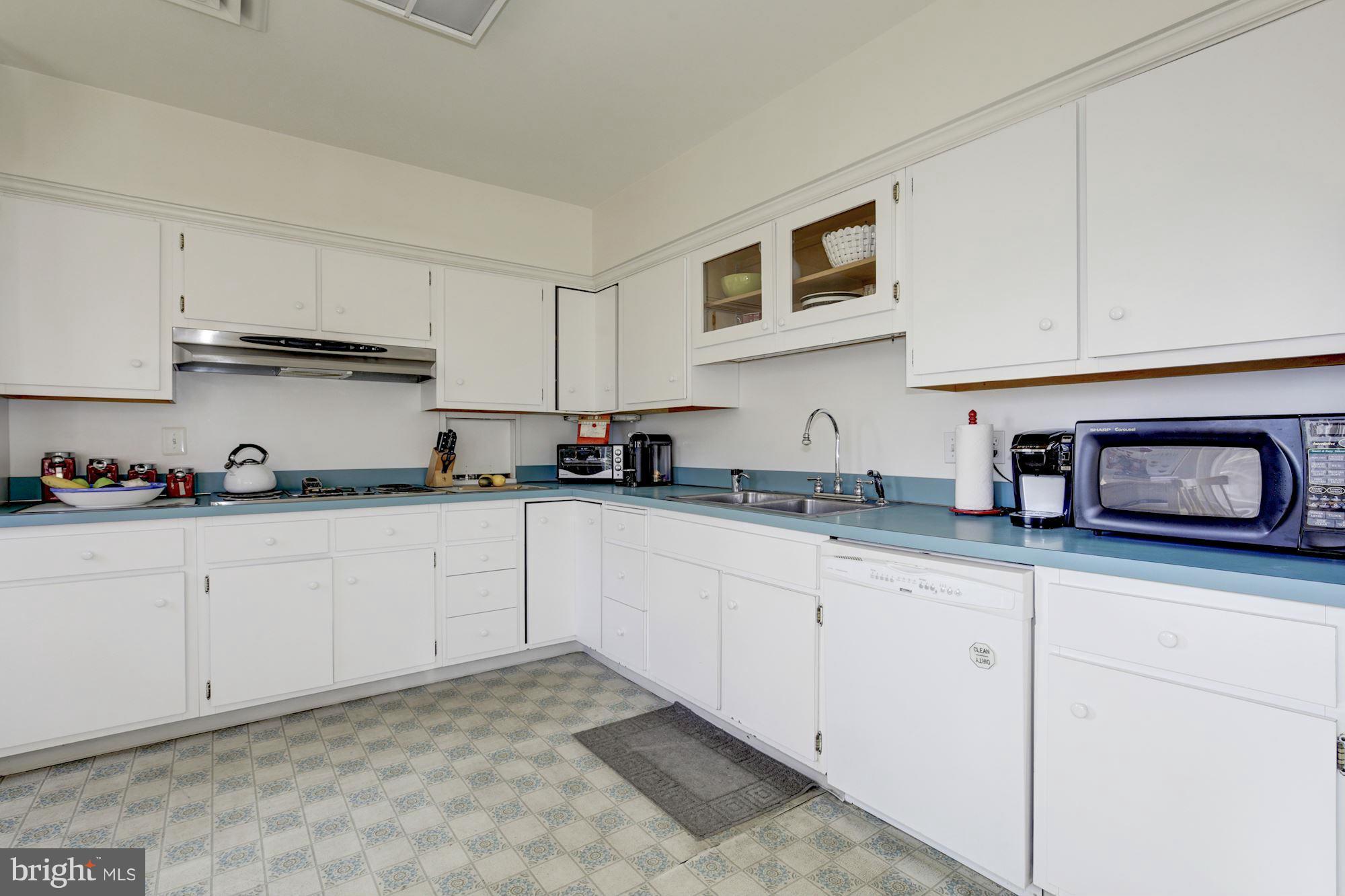6308 Lenox Road Bethesda, MD 20817 - Photo 11 of 30 a kitchen with granite countertop white cabinets and stainless steel appliances
