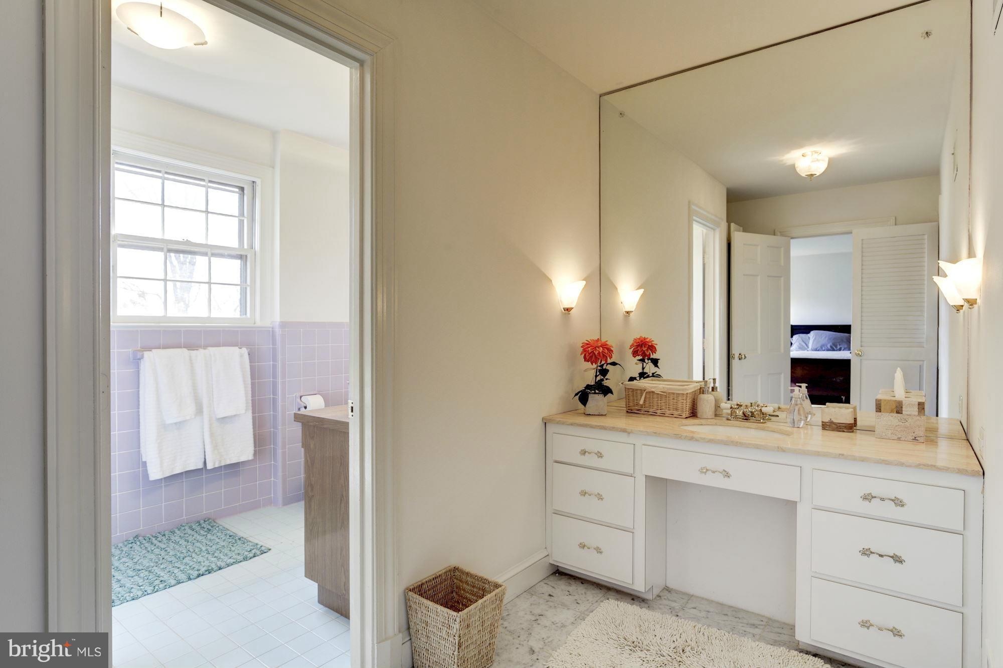 6308 Lenox Road Bethesda, MD 20817 - Photo 21 of 30 a bathroom with a sink vanity and a mirror