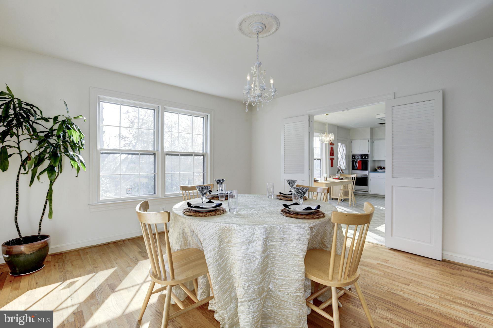 6308 Lenox Road Bethesda, MD 20817 - Photo 9 of 30 a dining room with furniture a window and a kitchen