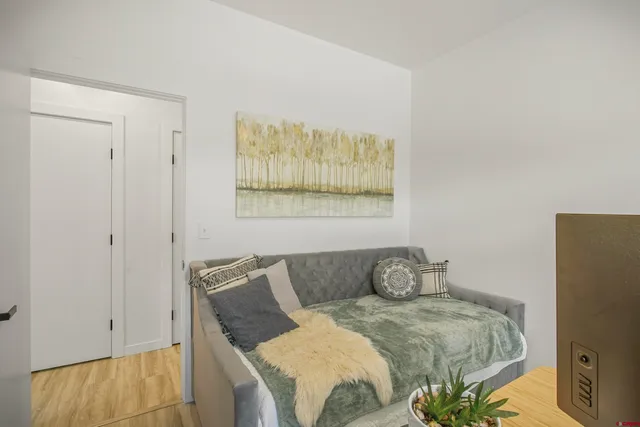 a hallway with stainless steel appliances lots of counter space and wooden floor