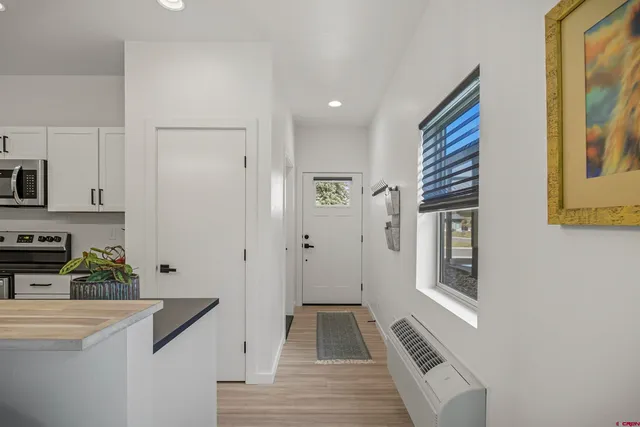 a kitchen with granite countertop a sink stainless steel appliances and cabinets