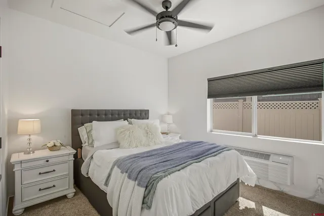 a bedroom with a bed and a mirror