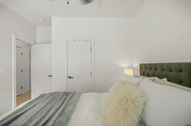 a view of bedroom with wooden floor and window