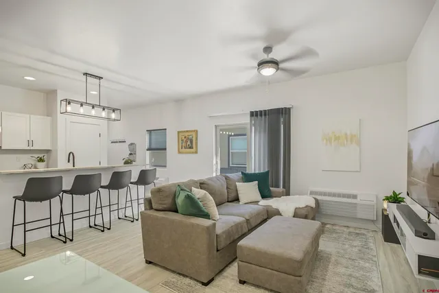 a living room with furniture and wall paintings