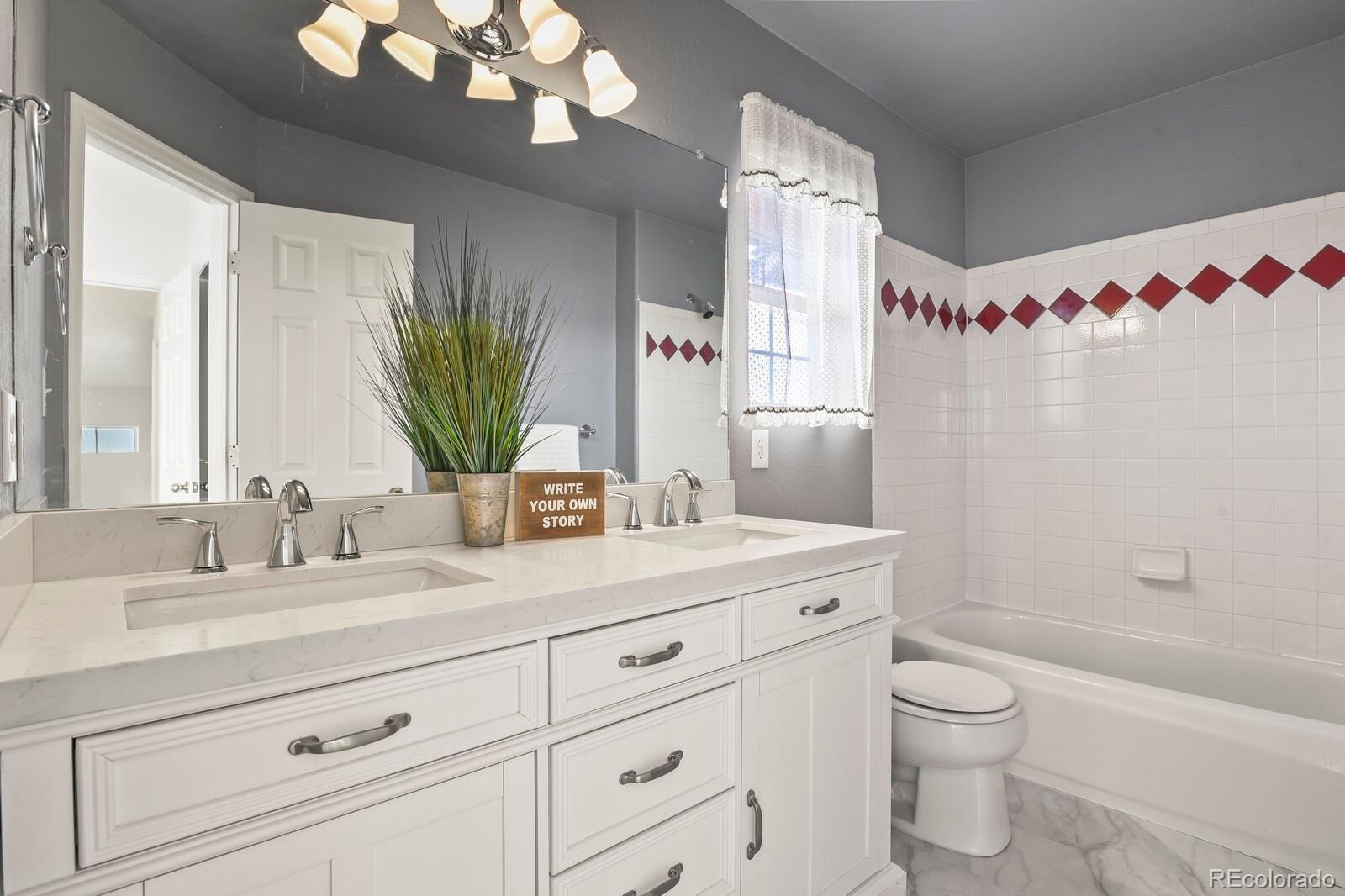 3244 Capstan Way Colorado Springs, CO 80906 - Photo 19 of 37 a bathroom with a granite countertop sink a toilet and a mirror