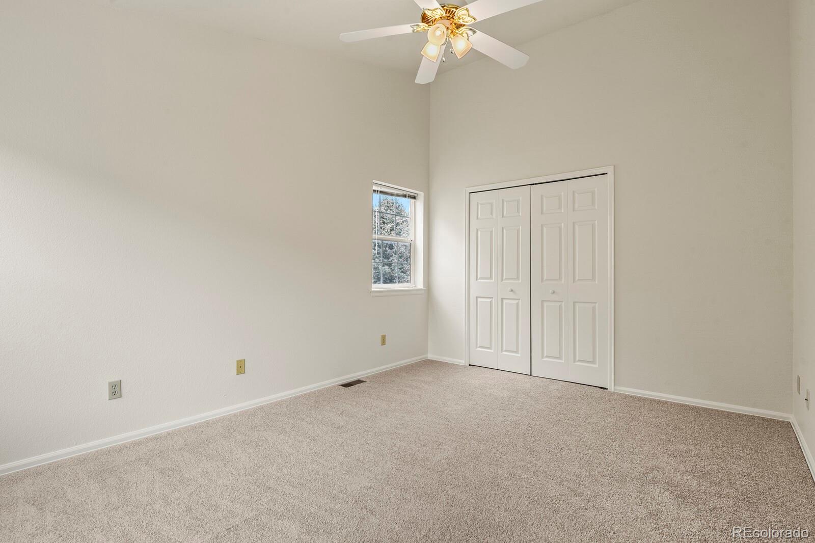 3244 Capstan Way Colorado Springs, CO 80906 - Photo 22 of 37 an empty room with a chandelier fan
