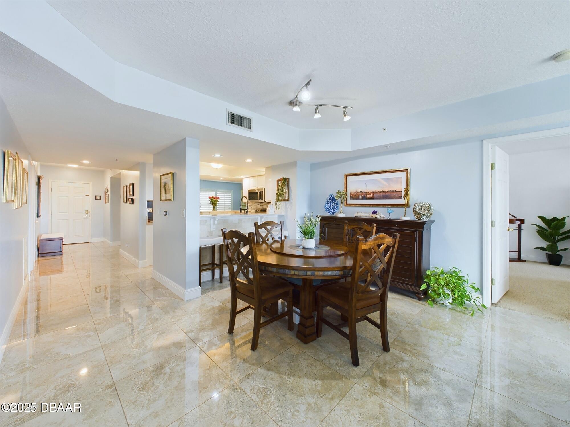 4670 Links Village Drive, Unit C601 Ponce Inlet, FL 32127 - Photo 11 of 68 a view of a dining room with furniture