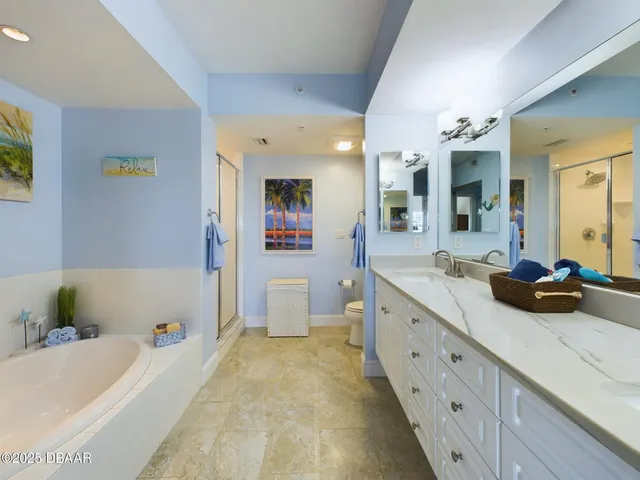 a bathroom with a bathtub and a chandelier