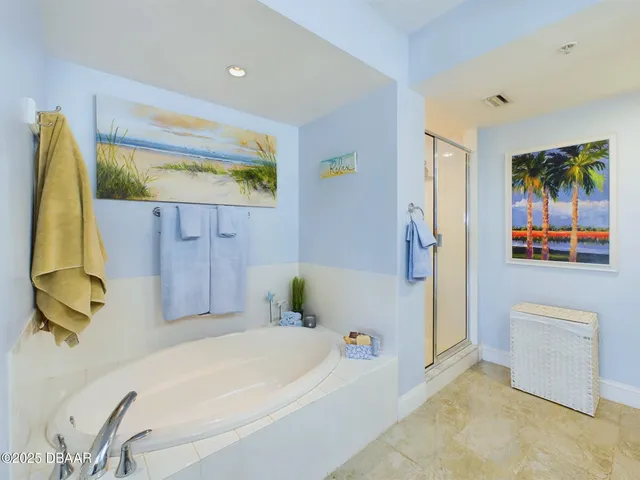 a bathroom with double vanity sinks a vanity a lamp and a glass door