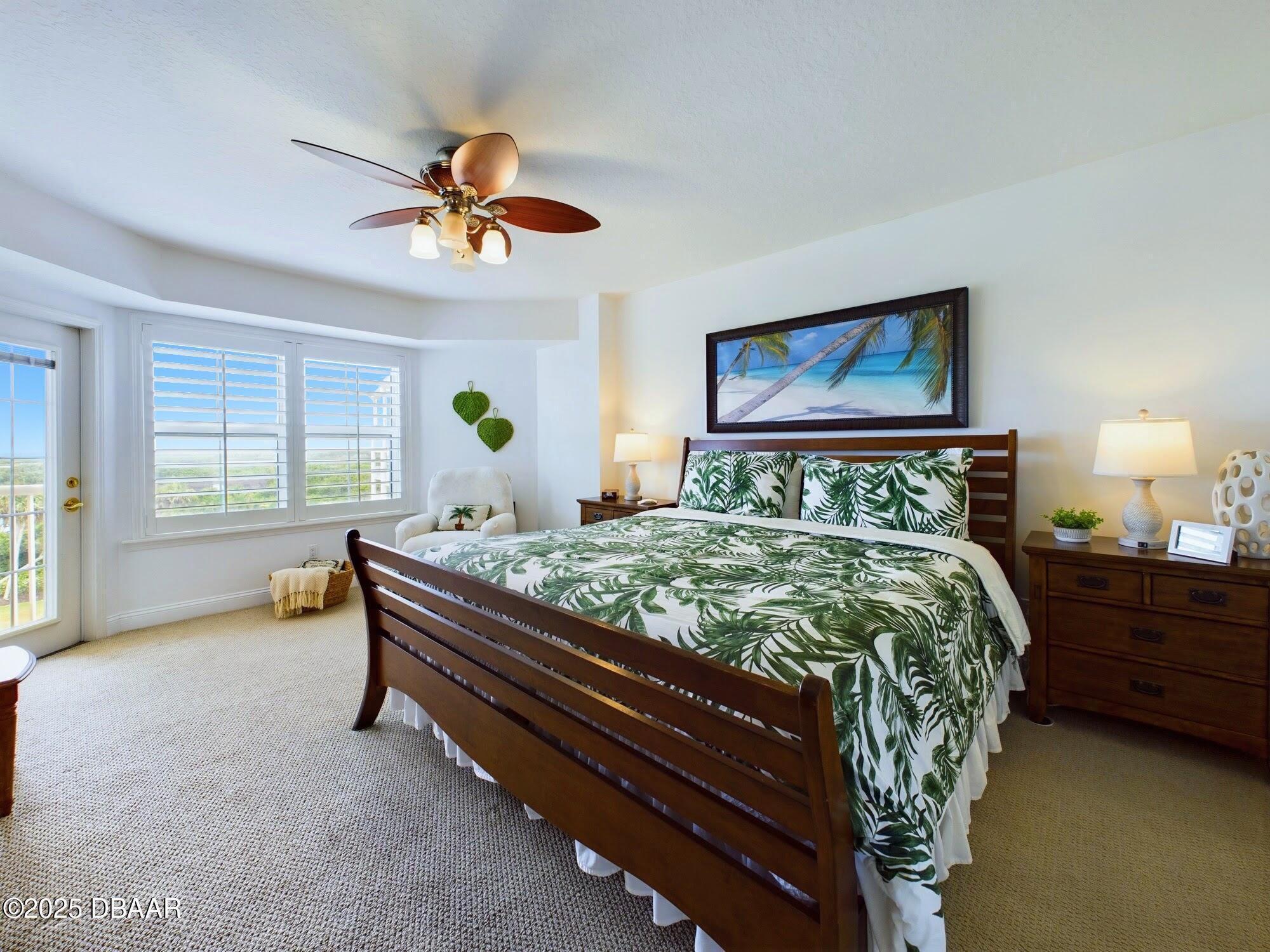 4670 Links Village Drive, Unit C601 Ponce Inlet, FL 32127 - Photo 41 of 68 a bed sitting in a bedroom next to a window