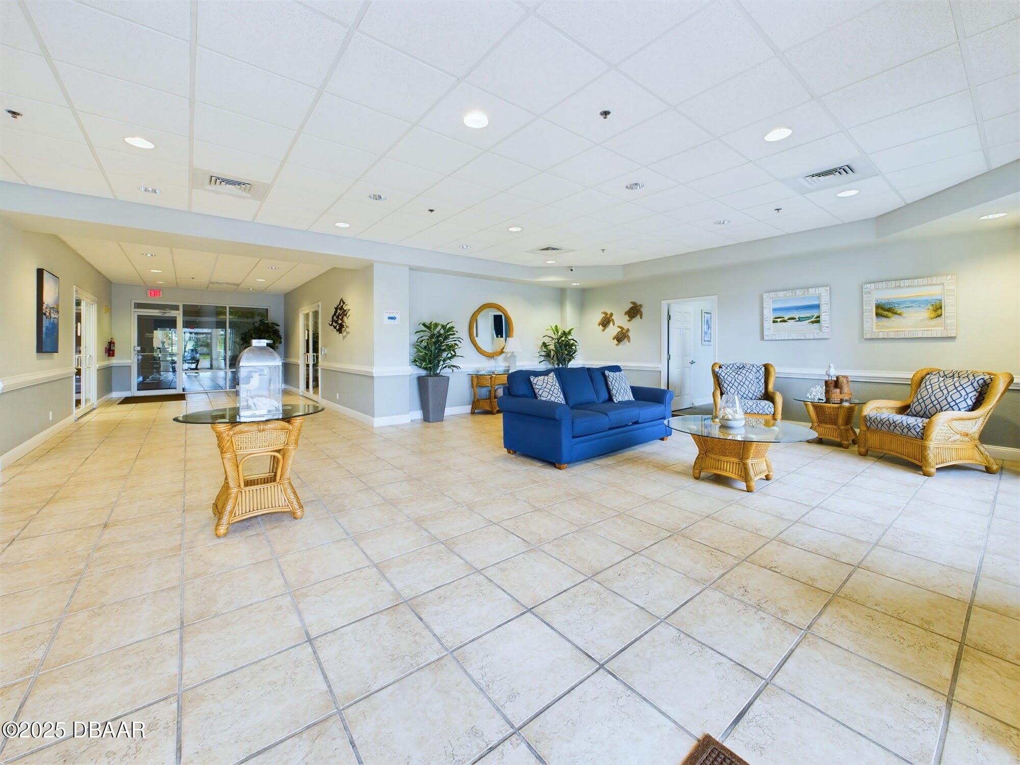 4670 Links Village Drive, Unit C601 Ponce Inlet, FL 32127 - Photo 49 of 68 a living room with furniture and a flat screen tv