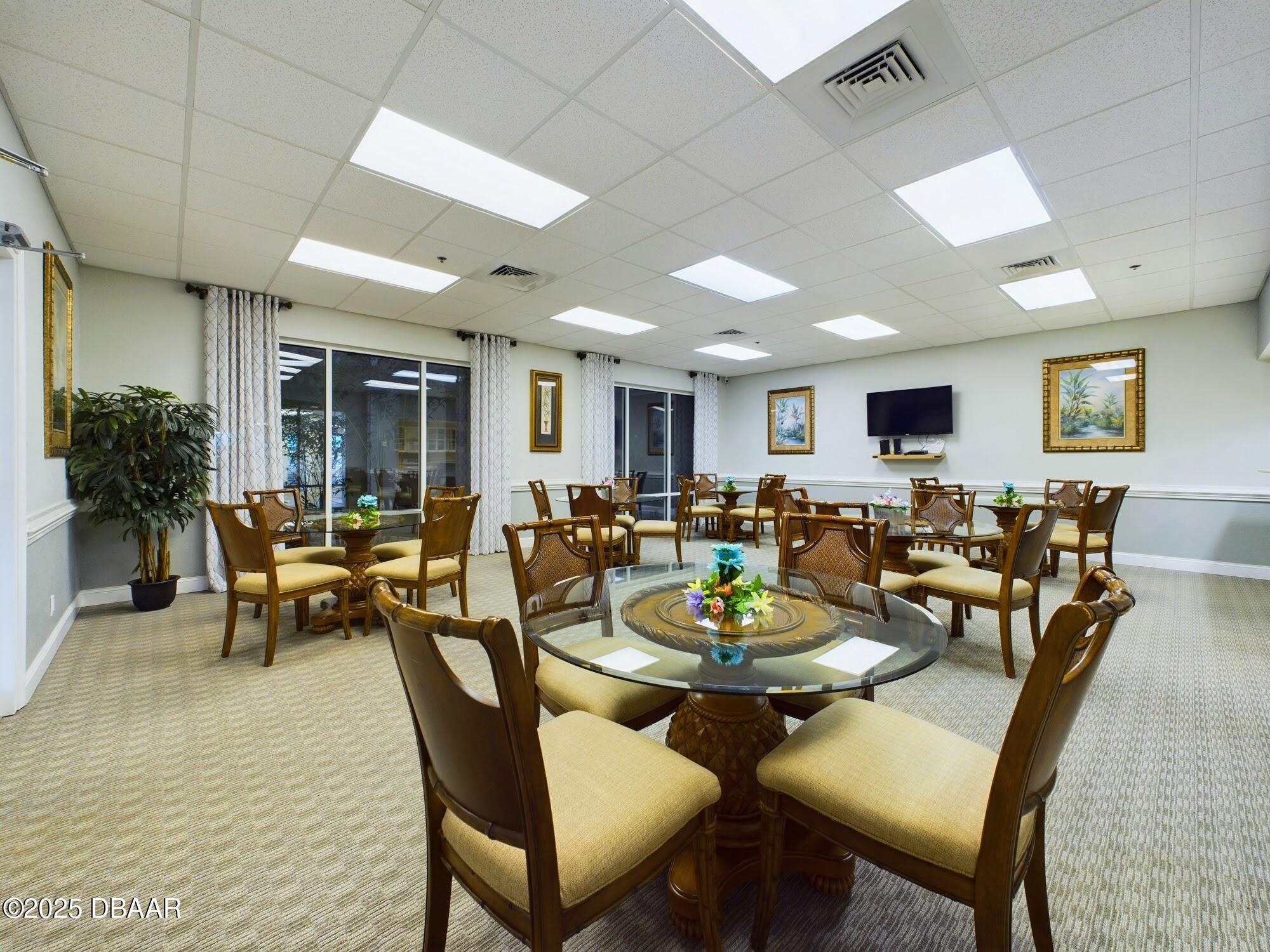 4670 Links Village Drive, Unit C601 Ponce Inlet, FL 32127 - Photo 52 of 68 a group of people sitting at tables in a room