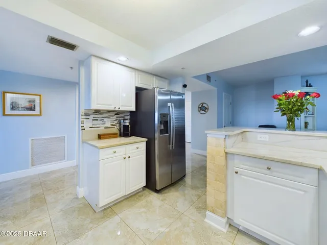 a kitchen with granite countertop white cabinets and white appliances