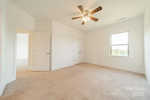 a bathroom with a granite countertop sink toilet a mirror and shower