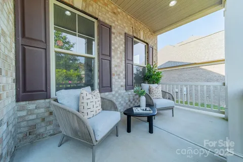 a living room with fireplace furniture and a large window