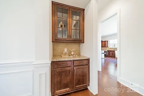 an empty room with chandelier fan