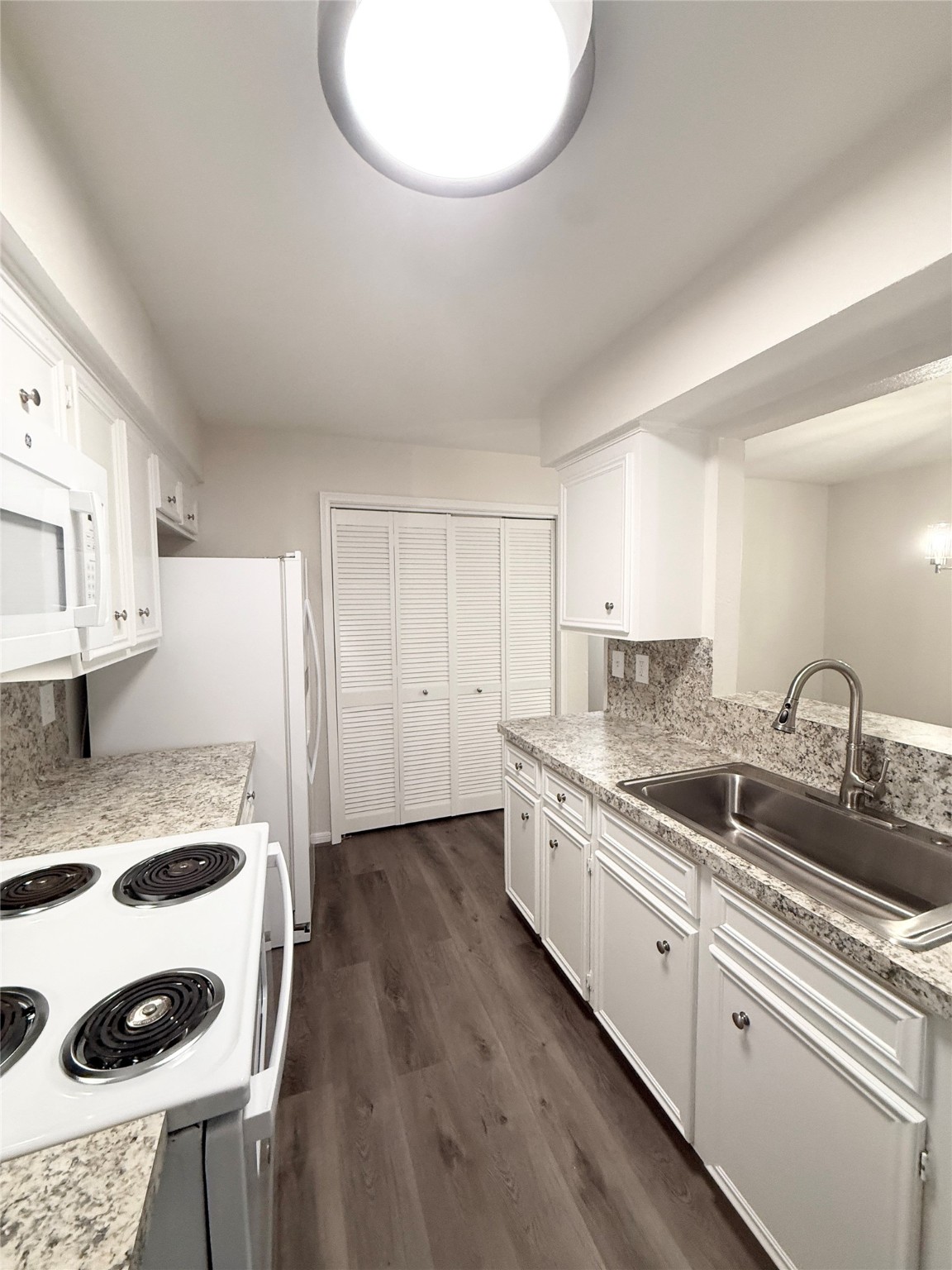 1477 Springrock Lane, Unit 12 Houston, TX 77055 - Photo 13 of 24 a kitchen with a sink a stove and cabinets