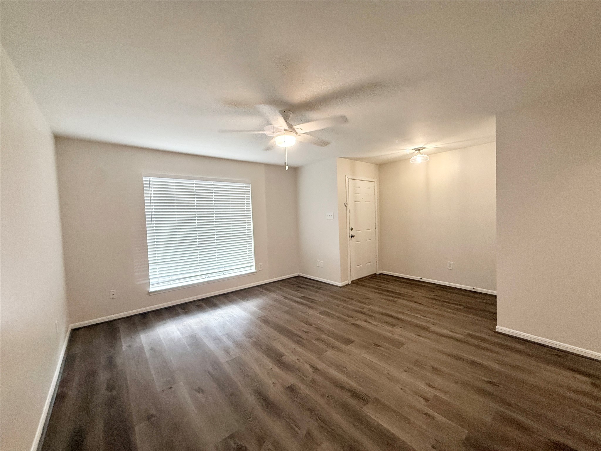 1477 Springrock Lane, Unit 12 Houston, TX 77055 - Photo 4 of 24 an empty room with wooden floor and windows