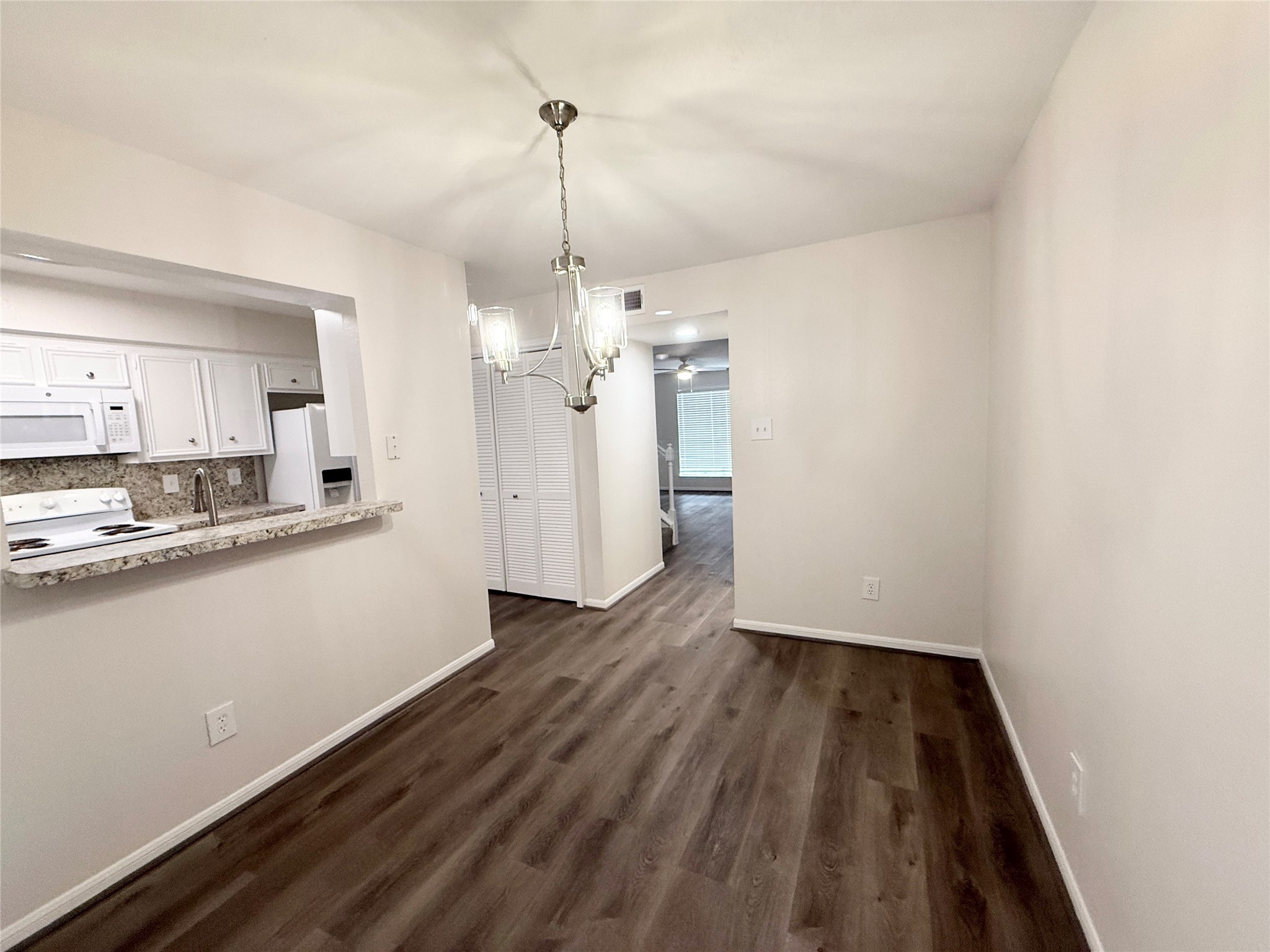 1477 Springrock Lane, Unit 12 Houston, TX 77055 - Photo 9 of 24 a view of a kitchen with a sink wooden floor and a window