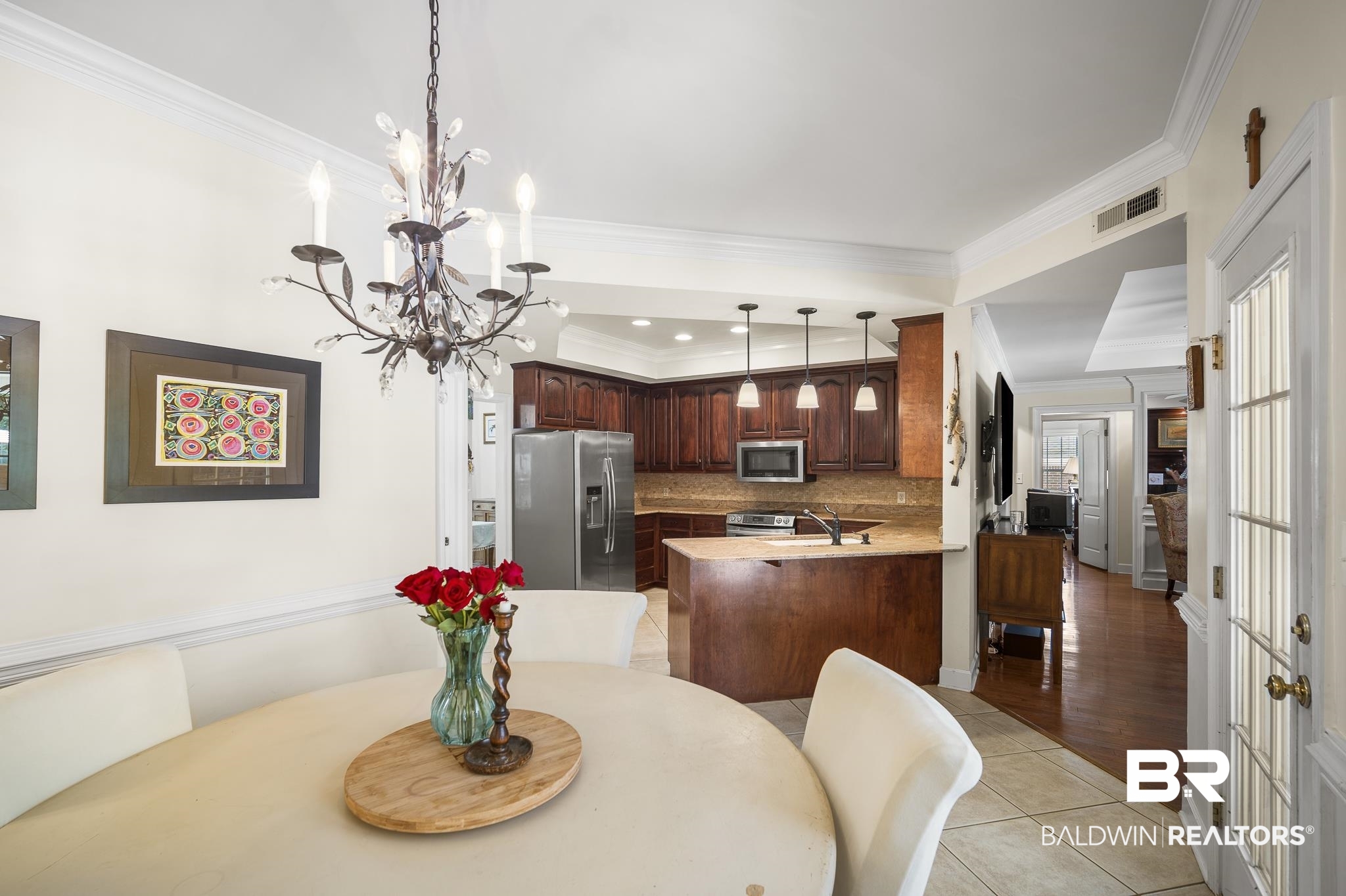 402 Potters Mills Road Daphne, AL 36526 - Photo 12 of 45 Dining space featuring crown molding, a chandelier, and light tile patterned floors