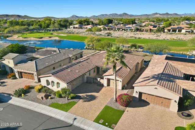 an aerial view of residential houses with outdoor space and river