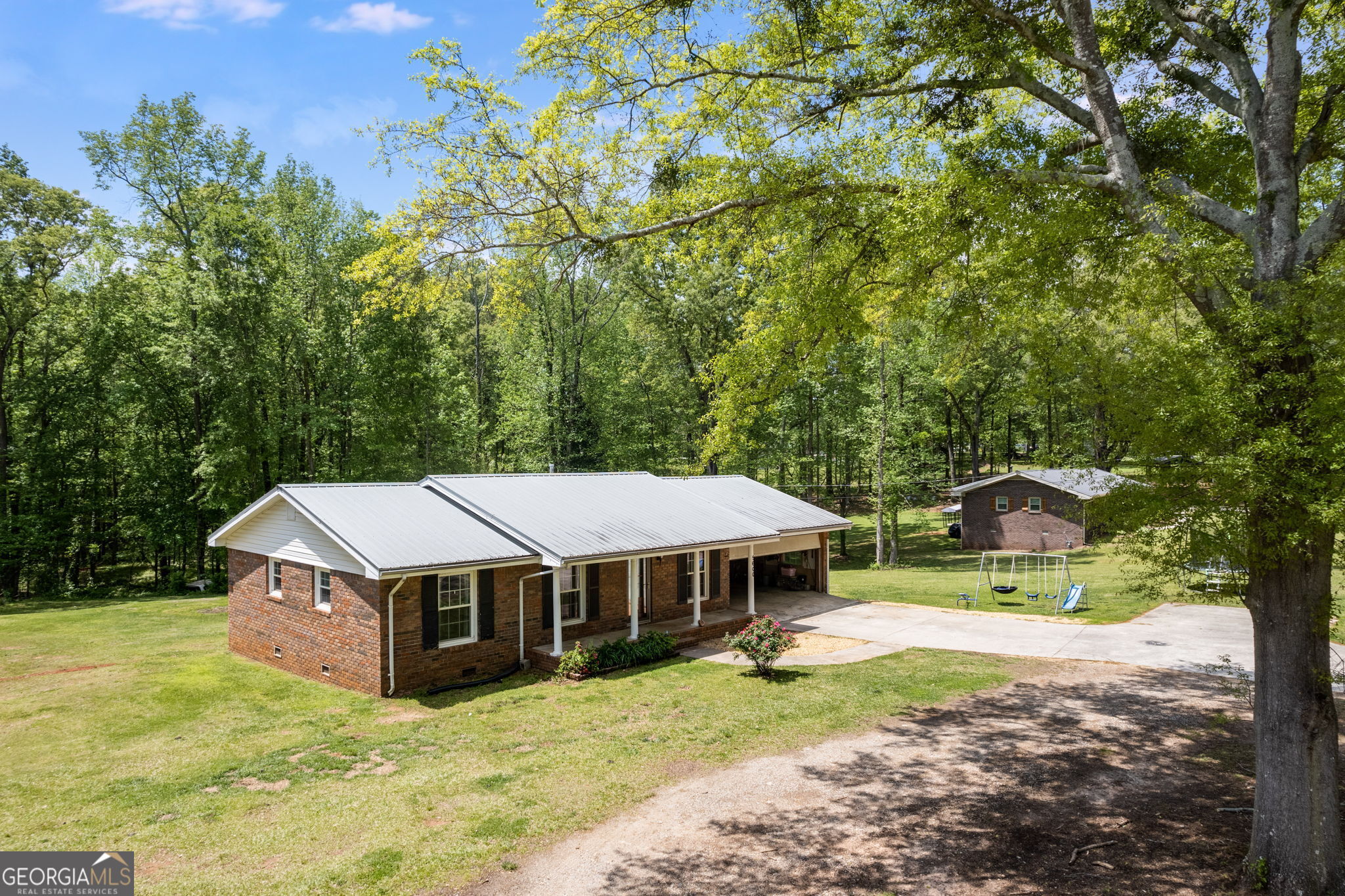 5600 Smithfield Road Bowdon, GA 30108 - Photo 1 of 1 a view of a house with backyard and a tree