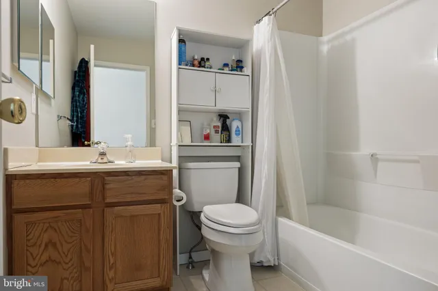 a bedroom with a bed and a flat tv screen on the dresser