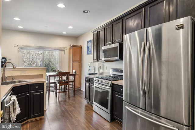 a kitchen with stainless steel appliances granite countertop a stove and a sink